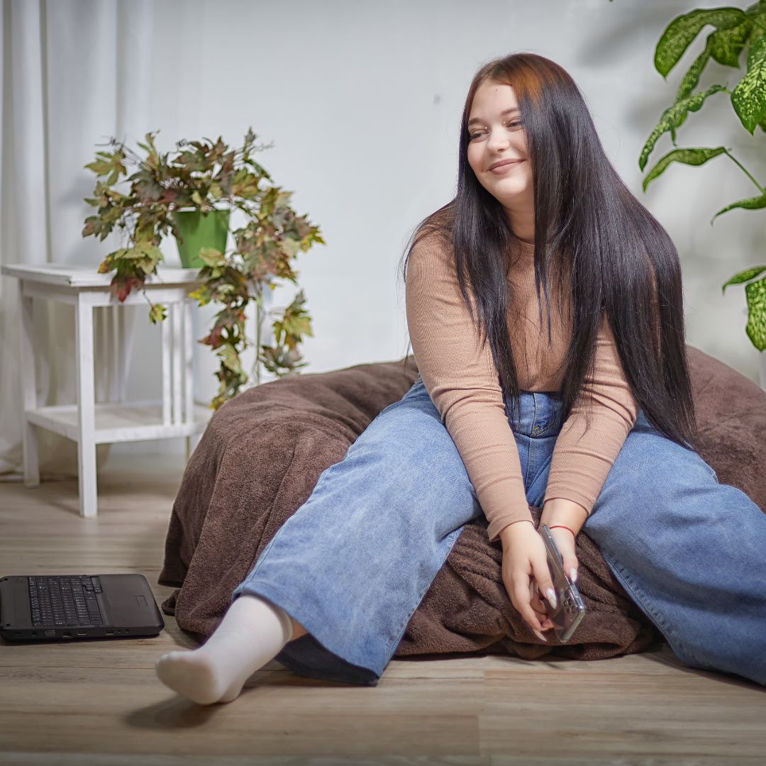 young autistic woman sitting in apartment